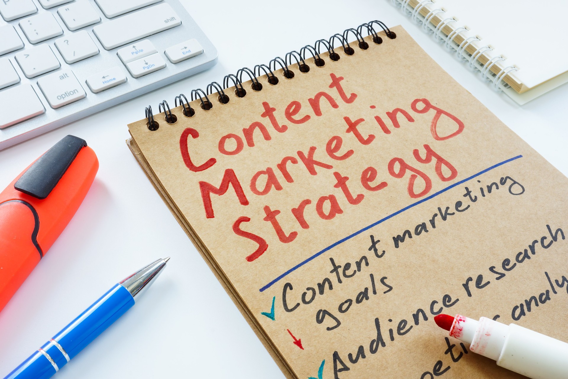 Handwritten Content marketing strategy and keyboard.